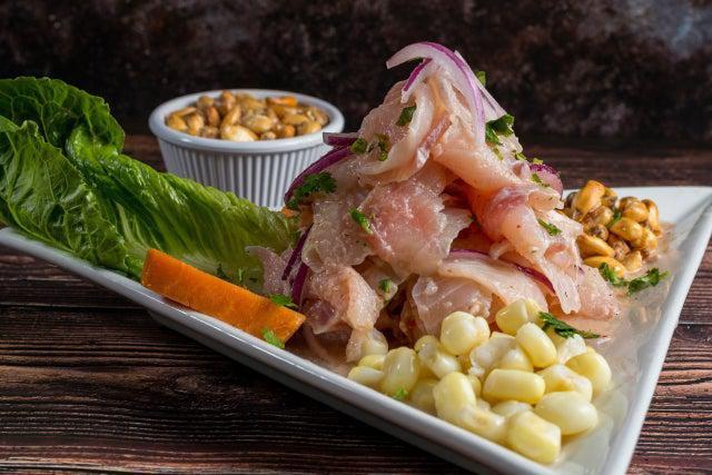 Ceviche · Raw fish(tilapia) marinated with lime served with onion corn sweet potatoes.