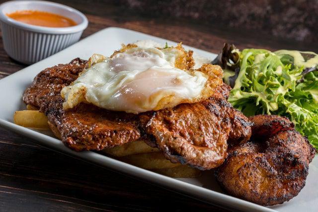 Pechuga a Lo Pobre · Grilled chicken breast served with rice, french fries, eggs, plantains, and salad.