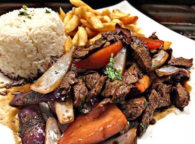 Lomo Saltado · Beef, tomato, onion sautéed in a fiery wok with french fries and white rice.