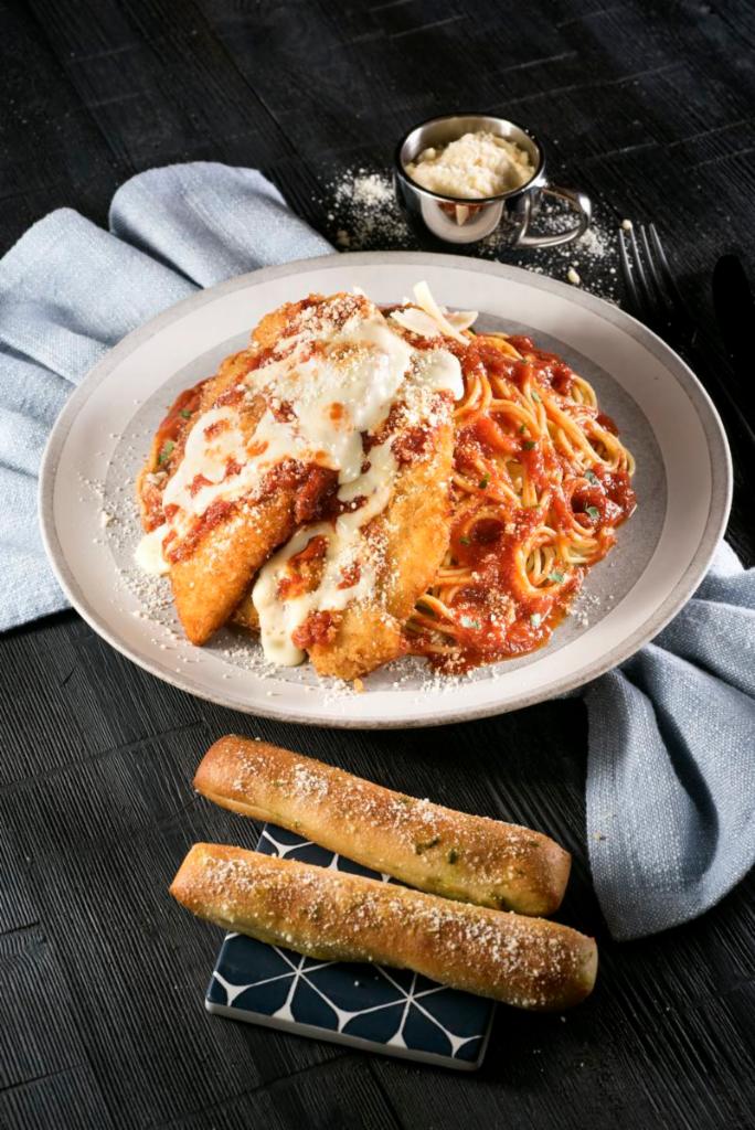 Chicken Parmigiana · Breaded chicken breast, mozzarella cheese and marinara sauce over a bed of spaghetti. Served with garlic bread.