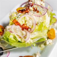 The Wedge · iceburg lettuce, blue cheese, cherry tomatoes, red onion, candied bacon, blue cheese dressing