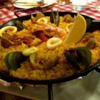Marisco Paella · Valencian rice, shrimps, calamari, jumbo shrimp, clams, green beans, red pepper, saffron.