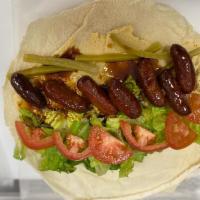 21. Makanek Wrap · Makanek (Lebanese sausages), hummus, lettuce, tomatoes, pickles.