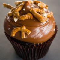 Caramel Crunch Cupcake · Chocolate cake with caramel icing topped with sea salt and pretzels.