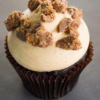 Peanut Butter Cup Cupcake · Chocolate cake with peanut butter cream cheese frosting topped with peanut butter cups.