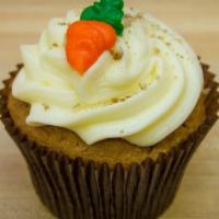 Carrot Cake Cupcake · Carrot cake with cream cheese frosting topped with pecans.
