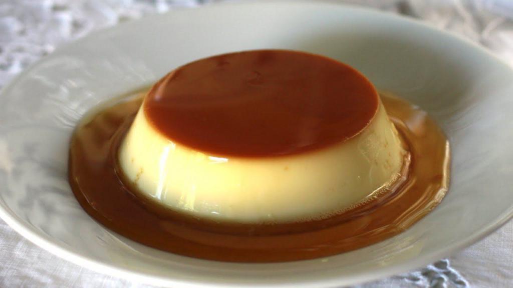 Caramel Flan · Creme caramel flan custard dessert with a layer of clear sauce and 1 scoop of ice cream.