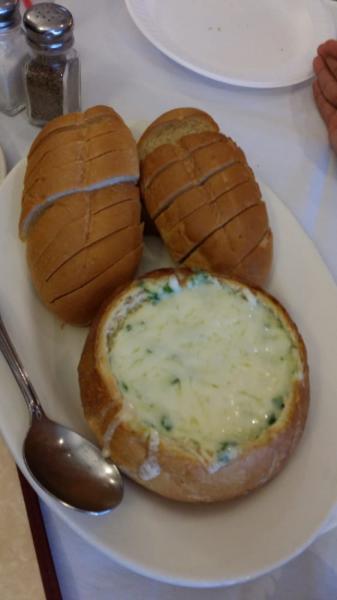 Spinach Artichoke Dip · Creamy Alfredo with spinach and artichoke topped with mozzarella cheese.