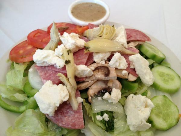 Greek Salad · Lettuce, onion, bell pepper, black olives, mushroom, tomatoes, cucumber, artichoke hearts, salami and feta cheese.