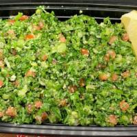 Tabbouli Salad · Chopped salad with tomatoes, scallions, and cracked wheat topped with lemon juice and herbs.