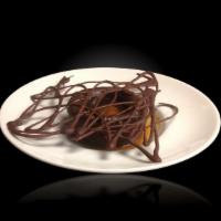Moelleux Mi-Cuit · Classic chocolate lava cake revisited with a creamy caramel core.