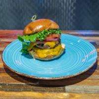 Cheeseburger · Black Angus Beef topped with Lettuce, Tomato, Onion, Cheddar Cheese, and our Special House S...