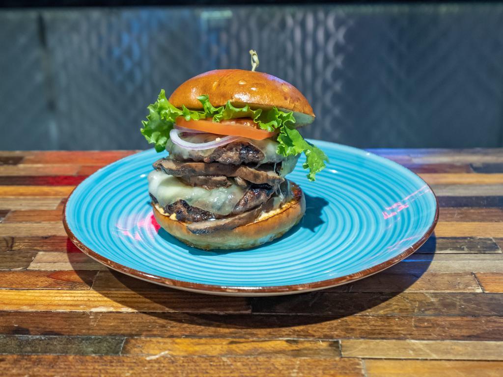 Shroom Burger · Black Angus Beef topped with a grilled Portobello Mushroom cap, Swiss Cheese, White Truffle Oil, Lettuce, Tomato, Onion, and our Special House Sauce on a Brioche Bun.