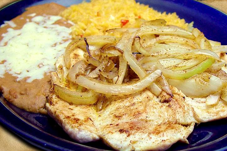 Pollo Asado · Chicken breast topped with grilled onions. Served with rice, beans refried or black, and tortillas flour or corn.