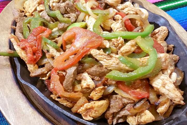 Mixed Fajitas · Grilled tender sliced beef and chicken, with bell peppers, onions, tomatoes all mixed. With flour or corn tortillas.