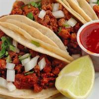 Tacos Al Pastor · 3 corn tortillas with marinated pork. Cooked with pineapple, onions, cilantro, and salsa. Ri...