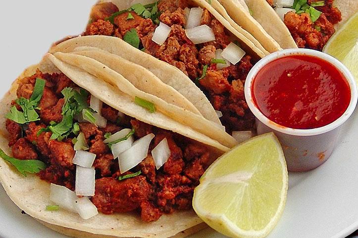 Tacos Al Pastor · 3 corn tortillas with marinated pork. Cooked with pineapple, onions, cilantro, and salsa. Rice and beans refried or black on the side.