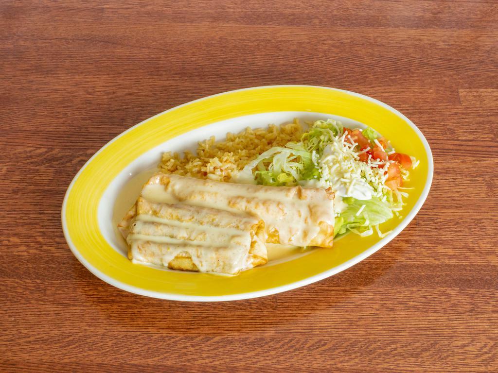 Grilled Chimichanga · Grilled onions, tomatoes, and bell peppers, wrapped in a flour tortilla deep-fried, and topped with our famous cheese sauce. Served with rice or beans refried or black. Garnished with lettuce, sour cream, guacamole, and fresh tomatoes.