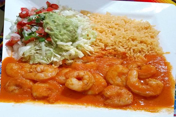 Camarones A la Diabla · Marinated shrimp in hot spicy sauce. Served with rice, lettuce, guacamole, tomatoes, and tortillas flour or corn.