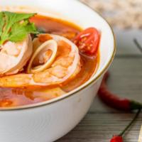 Tom Yum Soup · Mushrooms and tomatoes in a spicy broth with a touch of lemongrass and lime leaves.