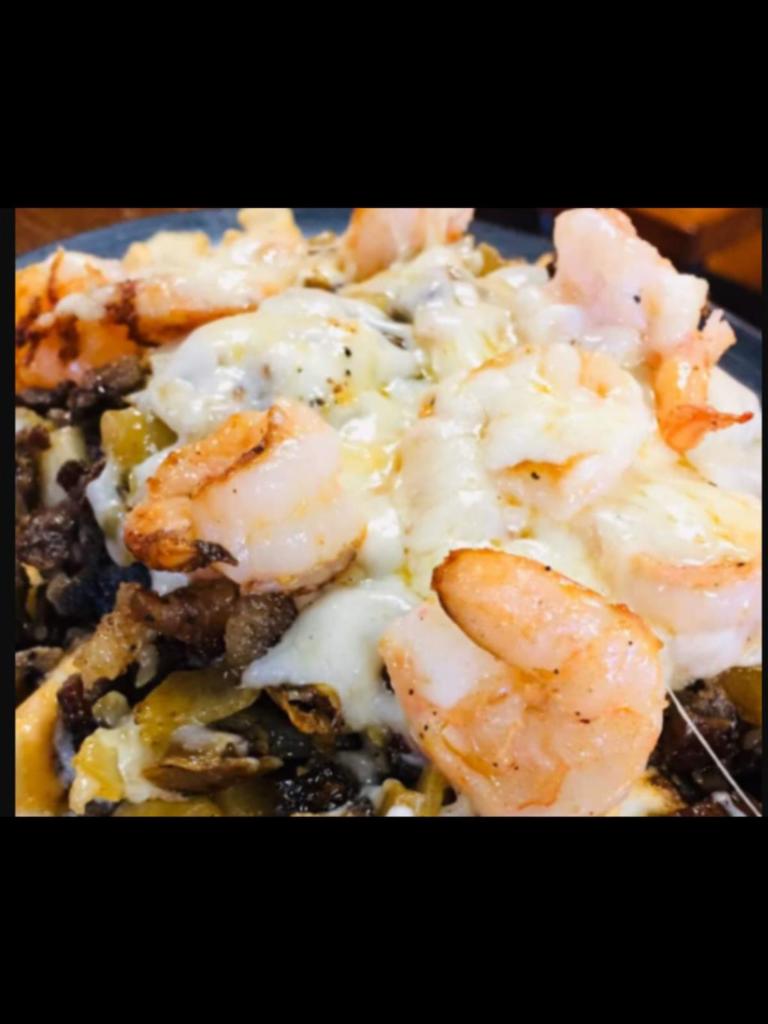 Earthquake Fries Plate · Protein: Marinated grilled shrimp with seasoned sliced steak served over rigged fries. Toppings: Freshly chopped cilantro, Monterey Jack cheese, drizzled with our house made chipotle sauce.