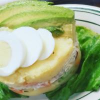 Causa Rellena de Pollo (chicken) · Spicy mashed potatoes stuffed with Chicken salad, avocado, peas, carrots & boiled egg & blac...