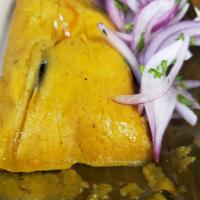 Chicken Tamal · Steamed corn masa filled with chicken & black olive wrapped in banana leaves.  Served with s...