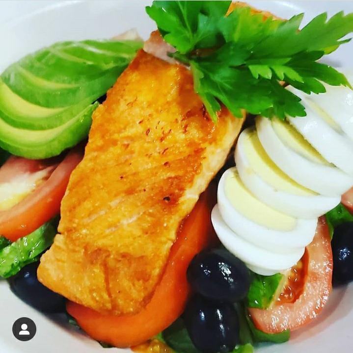 Salmon on The Bay Salad · Grilled Salmon, avocado, black olives, tomatoes & hard-boiled egg over crispy romaine lettuce with our fresh homemade dressing.