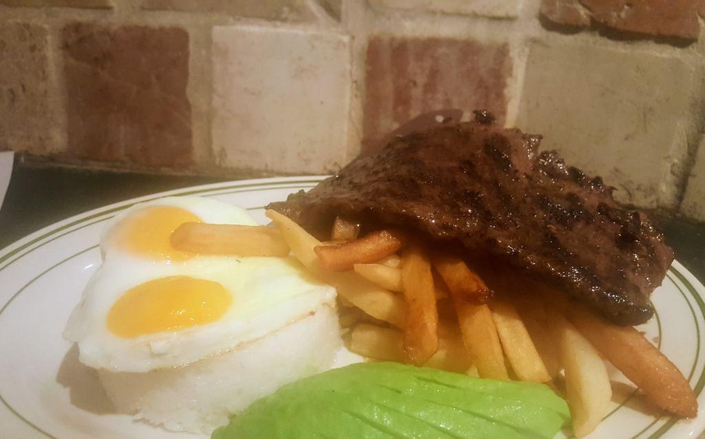 Skirt steak a Lo Pobre · 8 oz. Grass feed Skirt Steak, served with Jasmine rice, 2 fried eggs,  French fries & sweet Plantains.