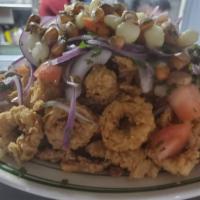 Jalea (Peruvian fried seafood platter) · Crispy fish bites, calamari, clam, mussels & shrimps served with fried yuca topped with sals...