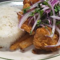 Chicharron de Pescado · Crispy fried fish bites served with Jasmine rice & fried yuca topped with salsa Criolla.