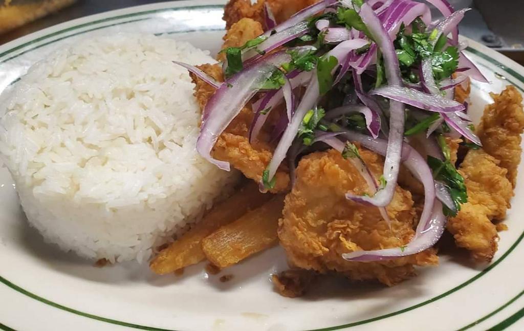 Chicharron de Pescado · Crispy fried fish bites served with Jasmine rice & fried yuca topped with salsa Criolla.