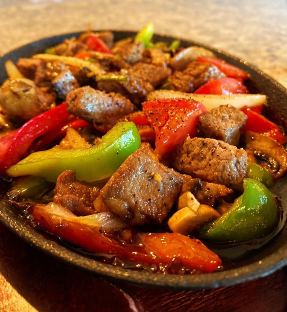 Shaky Beef Steak · Cube beef lion tri tip steak, onion, bell pepper, mushroom, tomato,garlic, butter and steam rice.
Served open a scorching hot steel pan.
