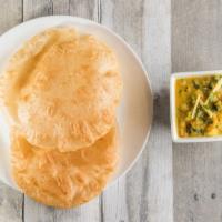Poori  · Fried puffed whole wheat bread served with mashed potatoes