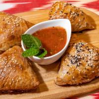 Tandir Samsa with Meat · Finely chopped lamb and beef meat, onion, spices wrapped in layered dough, and cooked in tan...