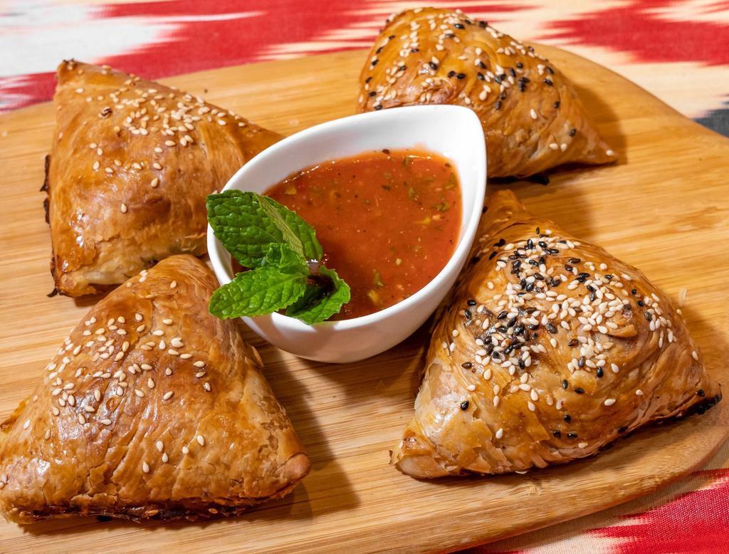 Tandir Samsa with Meat · Finely chopped lamb and beef meat, onion, spices wrapped in layered dough, and cooked in tandir.