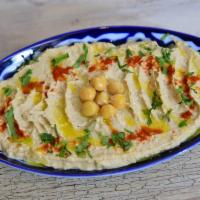 Hummus · Mashed chickpeas blended with tahini, olive oil, lemon juice, salt, and garlic.