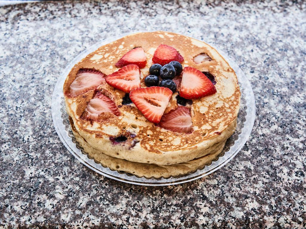 Wild Pancake · Three buttermilk pancakes loaded with your choice of blueberry, strawberry, coconut or banana.