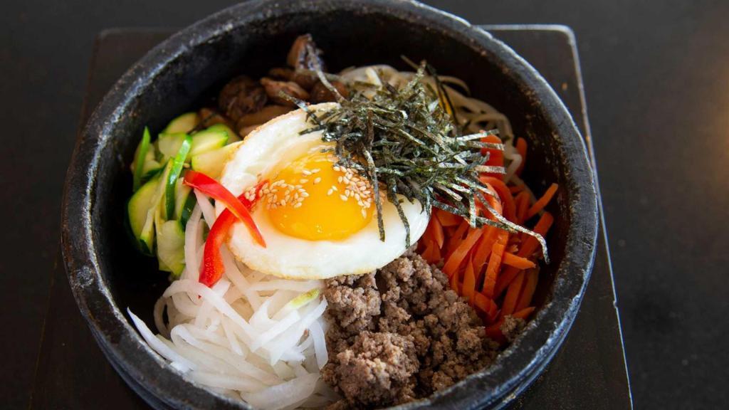 CLASSIC HOT STONE BIBIMBOP · Assorted vegetables, sunny side upegg and beef in a stone hot pot. made with crispy rice for takeout orders 