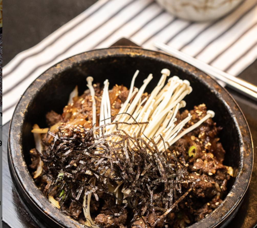 Bulgogi Stone Bibimbap · Rice cooked in bulgogi marinade with caramelized onions, scallions, roastd seaweed and a bed of bulgogi on top.