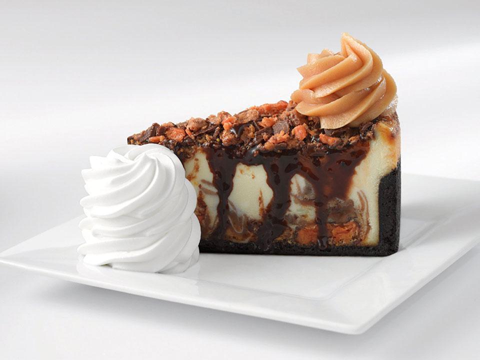 Caramel Peanut Butter Cake · A heavenly combination of peanut butter mousse, chopped snickers, caramel, peanuts, milk, and dark chocolate on a chocolate crumb crust. Incredible!