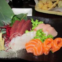 Sashimi Deluxe · 16 pieces sashimi with 1 bowl rice. Served with soup or salad.