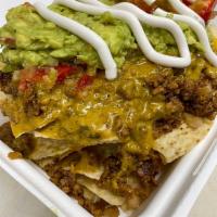 Loaded Nachos Platter · A bed of nachos, loaded with chopped meatless, cheesy sauce, beans, house made salsa and sou...