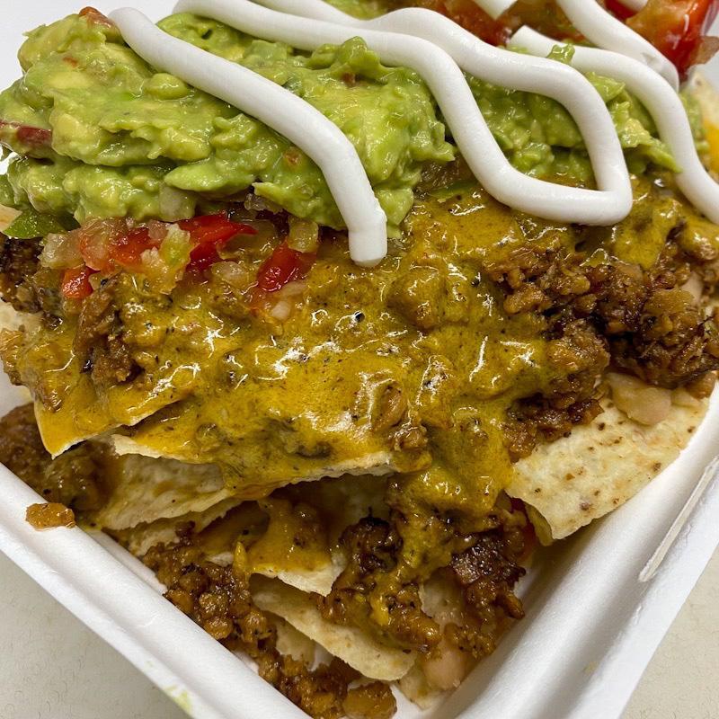 Loaded Nachos Platter · A bed of nachos, loaded with chopped meatless, cheesy sauce, beans, house made salsa and sour cream. Sure you can add guacamole or all of your favorite toppings. 