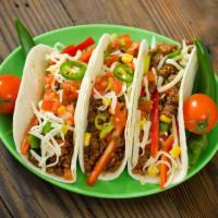Tacos Platter · 3 double layered corn tortillas stuffed with chopped meatless, cheesy sauce, lettuce, tomato...