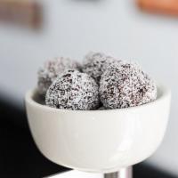 Chocolate Cherry Energy Bites · Organic dates, apricots, and cherries. Chocolate chips, chia seeds & coated in coconut sprin...