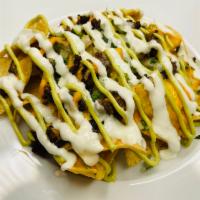 Nachos Supreme · Fresh tortilla chips topped with your choice of meat, beans, sour cream, avocado crema, cila...