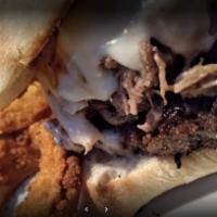 OG Philly Sandwich · Shaved ribeye steak, provolone, sauteed onions, green bell peppers, and mushrooms on a toast...