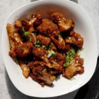 BBQ Cauliflower · Fried cauliflower florets, tossed in house BBQ rub with a side of BBQ sauce.
