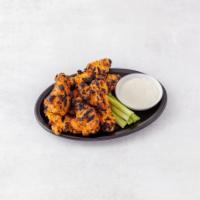 Baked Buffalo Wings · Served with bleu cheese and celery.